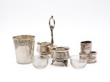 silver plated tea set with cups and saucers on a white background