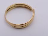 a close up of a gold ring on a white surface