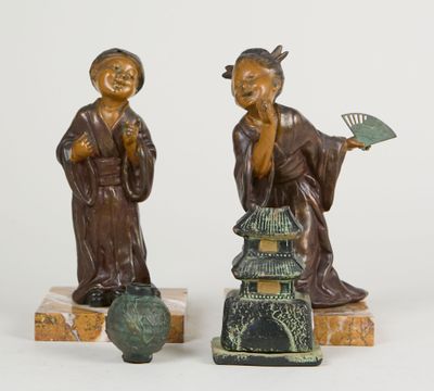 pair of asian figurines of a man and a woman holding a fan