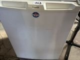 a white refrigerator that is sitting on the floor
