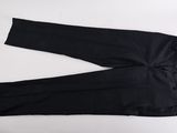 black pants on a white table with a pair of scissors