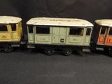 three toy trains sitting next to each other on a black surface