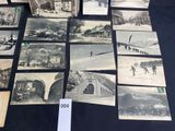 some old black and white photos of people and buildings on a table