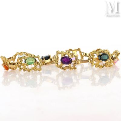 an image of a gold bracelet with multi colored stones on it