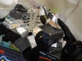 a pile of clothing and other items on a bed