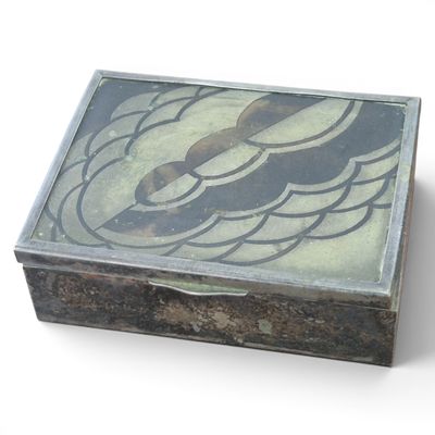 a wooden box with a design on it on a white surface