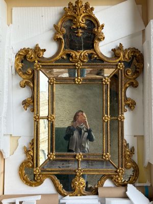 a woman taking a picture of herself in a mirror