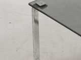 a glass table with a remote control on top of it