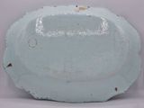 a large blue plate with holes in the middle