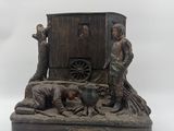 statue of a man and a woman in front of a horse drawn carriage