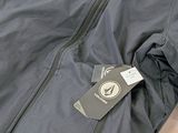 a blue jacket with a tag on it sitting on a table