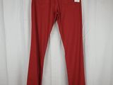 a pair of red pants hanging on a white curtain