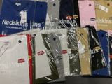 a lot of t - shirts wrapped in plastic on a table