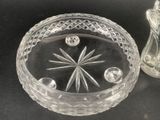 a glass bowl and a glass candle holder on a table