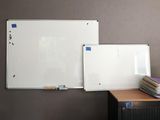 a white board on the wall next to a pile of books