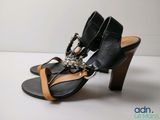 an image of a pair of black sandals with chains on them