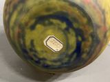 a yellow and green vase with a sim card in it