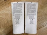 two tubes of toothpaste sitting on a wooden table