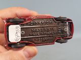 a person holding a small toy car in their hand