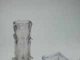 two glass vases sitting next to each other on a table