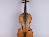 an old violin sitting on top of a white surface