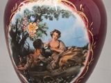a vase with a picture of a woman and a dog on it