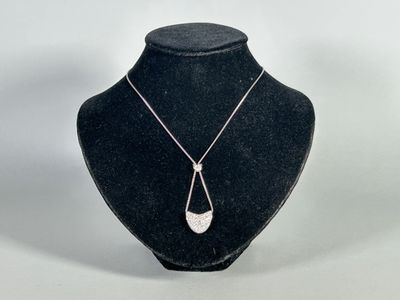 a black mannequin with a silver necklace on it