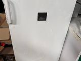 a white refrigerator in the middle of a pile of boxes