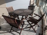 a table and chairs on the balcony of a house