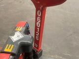 an image of a red and black hand truck with a steering