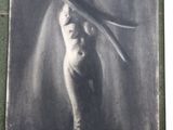 a black and white photo of a woman with a bird on her head
