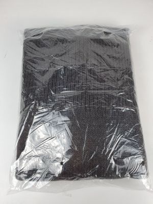 a close up of a bag of black plastic material on a white surface