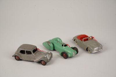 three toy cars sitting next to each other on a white surface