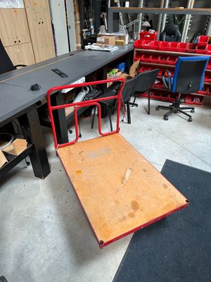 a desk with a chair and a table in the middle of the room