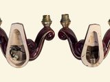 pair of red and white sconces with brass fittings on them