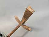 a wooden stick sticking out of a vase on a table