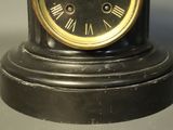 a black and gold clock with roman numerals on it