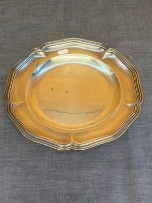 une photo d'un plat en argent posé sur une table recouverte d'une nappe bleue