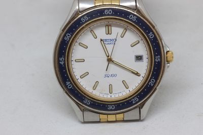 a watch that is sitting on a white surface