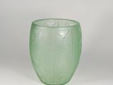 green glass vase on a white surface with a white background