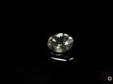 a close up of a green diamond on a black surface