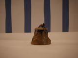 a small statue of a dog sitting on top of a table