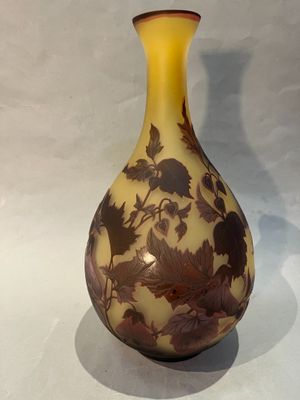 a vase that has a brown and yellow design on it