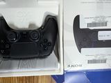 packaging of a black controller in a white box on a table