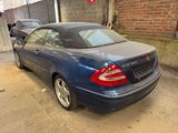 a blue car that is parked in a garage