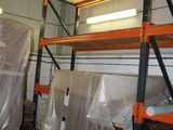 a room with a lot of shelves and pallets in it