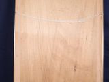 an empty wooden easel with a wooden top and a blue background