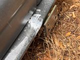 a close up of a car ' s bumper with a bullet on it