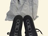 a pair of shoes that are next to a bag