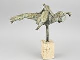 sculpture of a man on a horse on a block